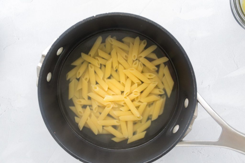 pasta and water in a black pot