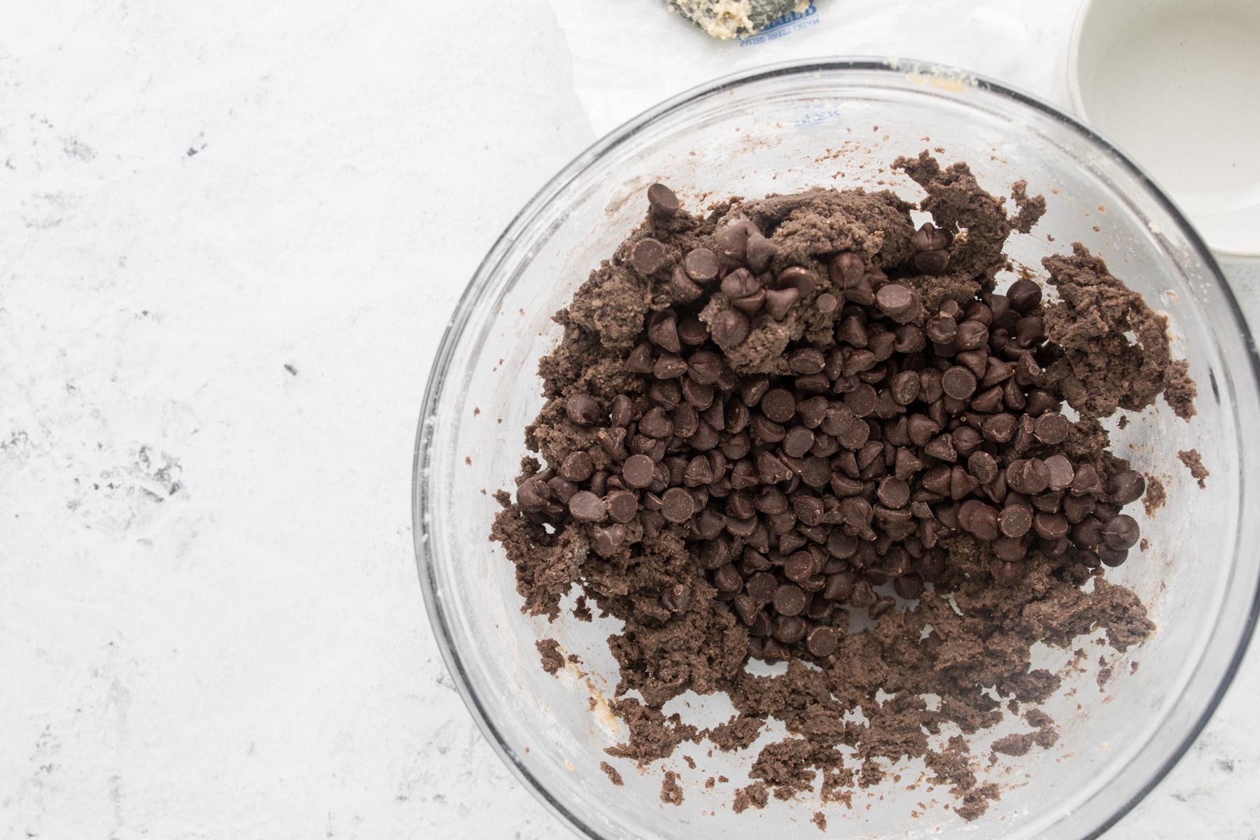 dark chocolate cookie dough with chocolate chips in a glass bowl