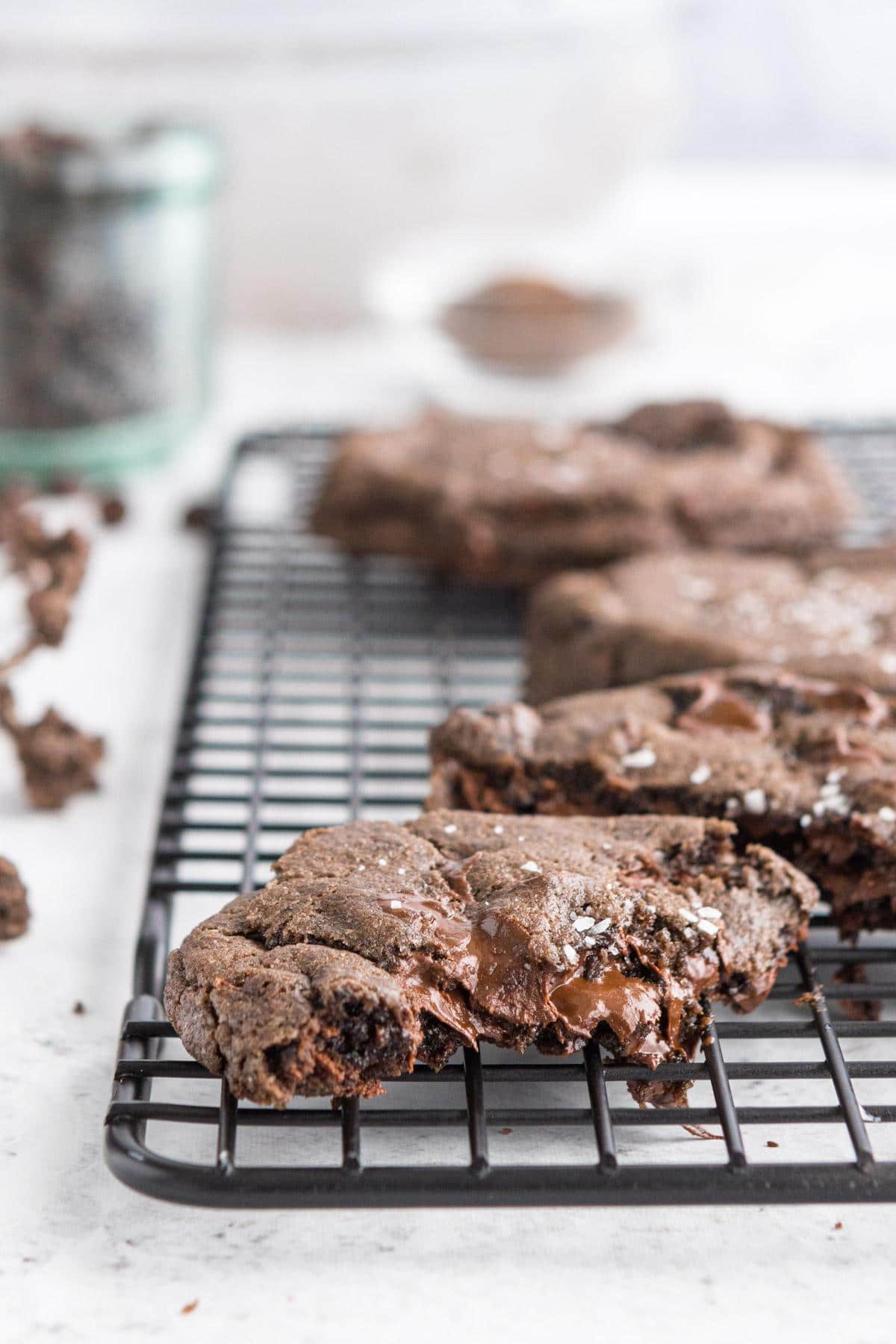 close up of a cut double chocolate cookie with more in the background