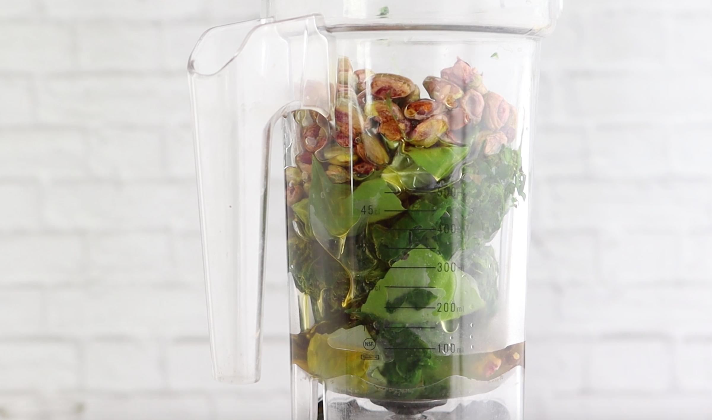 spinach, basil, pistachios, and olive oil in a blender