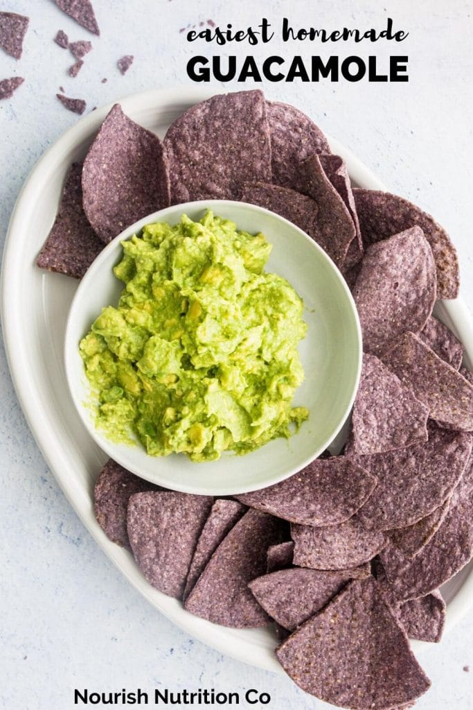 healthy guacamole in a bowl with blue tortillas and text overlay