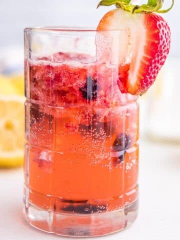 square image of sparkling berry lemonade in a glass
