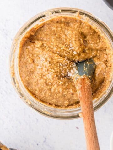 square image of honey almond butter in a glass jar