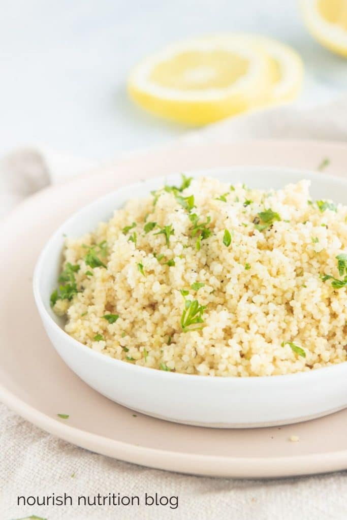 couscous with parsley on a pink plate with text overlay