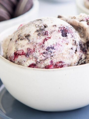 a scoop of blueberry oreo ice cream in a bowl