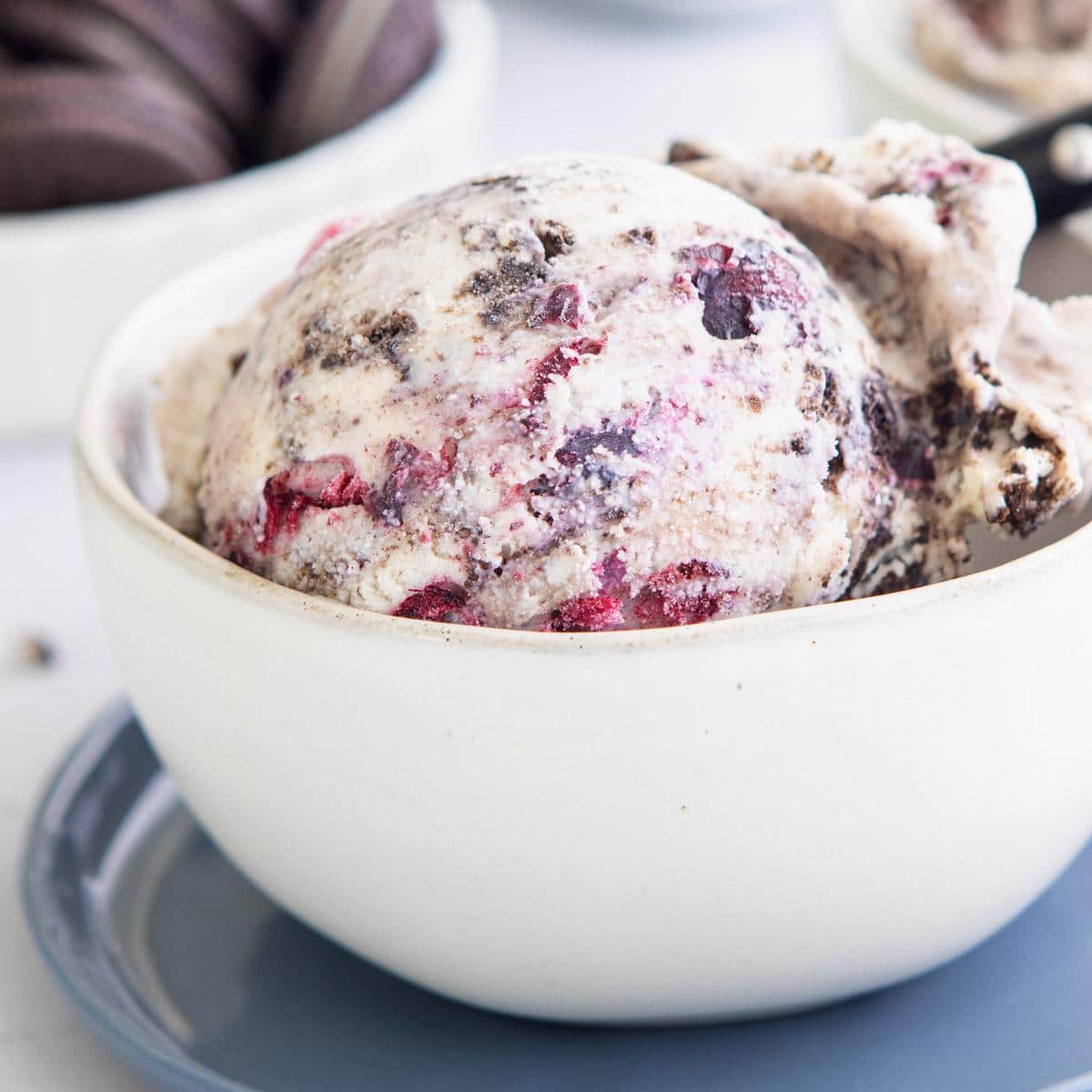 a scoop of blueberry oreo ice cream in a bowl