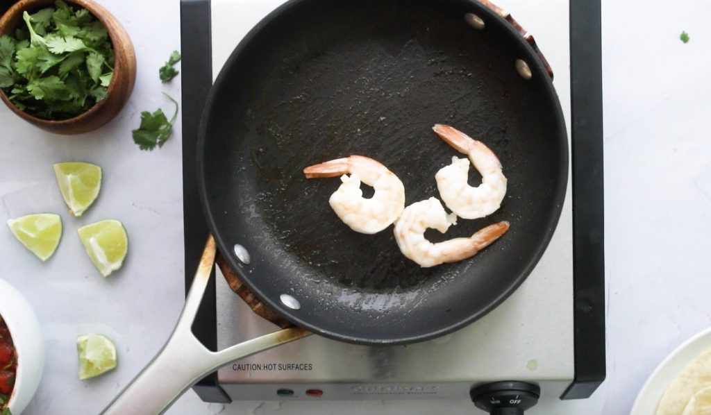 3 cooked shrimp in a pan