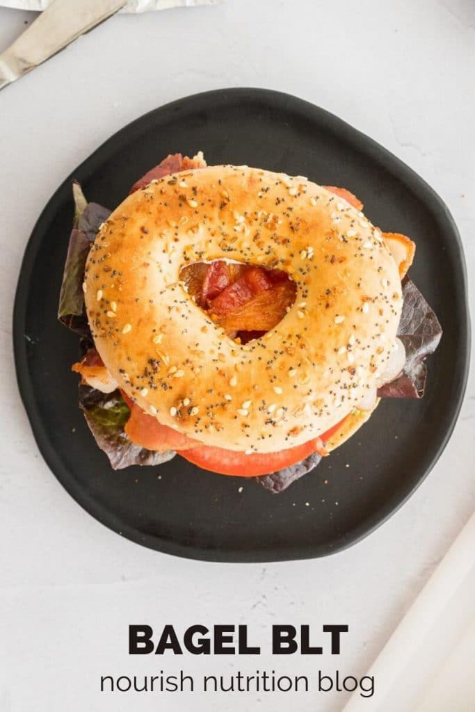 bagel sandwich on a black plate with text overlay