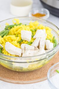 chicken and yellow rice in glass bowl