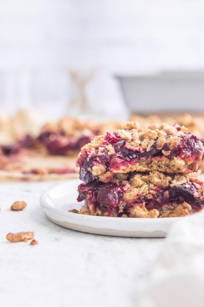 two cherry oatmeal bars stacked with more in background