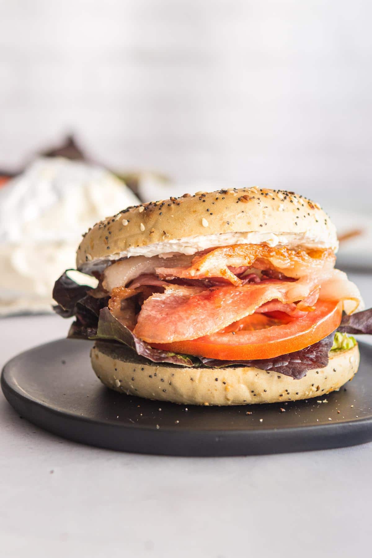 Bagel BLT on a black plate