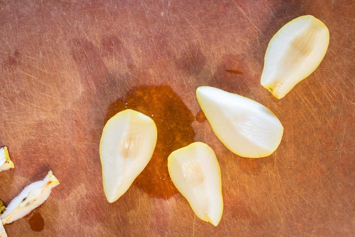four slices of pear on a cutting board
