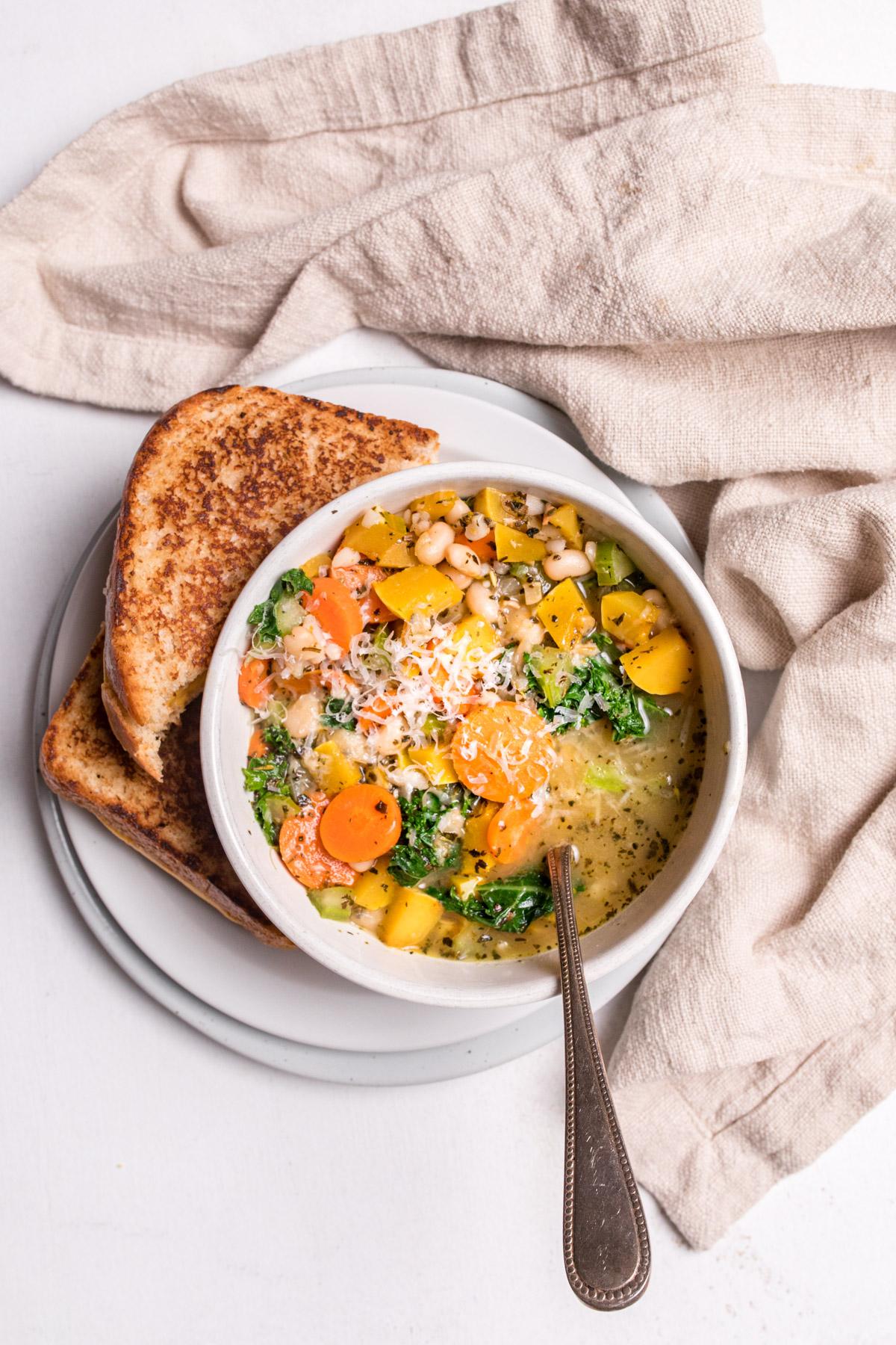 delicata squash soup with grilled cheese on a grey plate