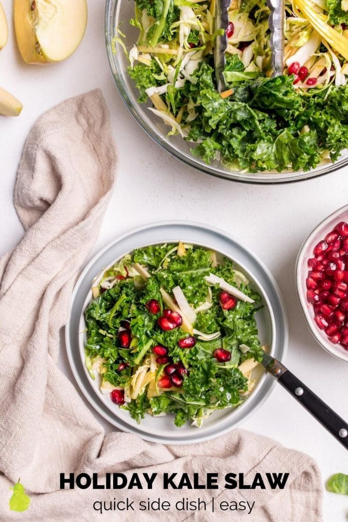 kale salad with pomegranate seeds and a fork in it
