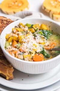 close up of vegetable soup in a white bowl