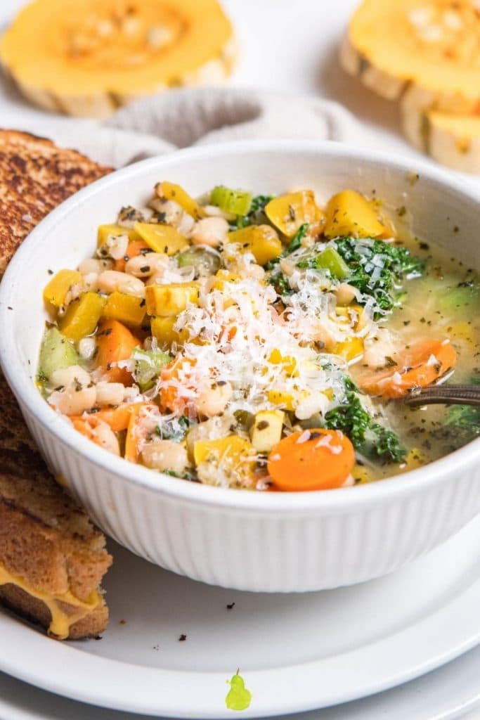 delicata squash soup in a white bowl with logo