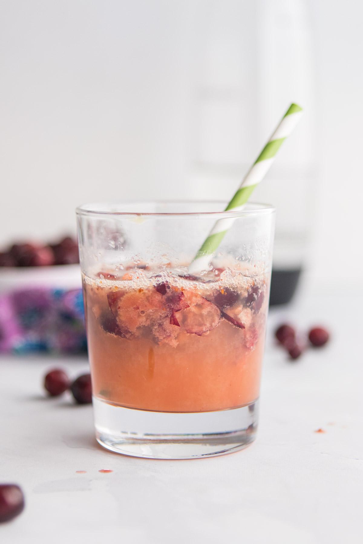 small glass with cranberry juice and smashed cranberries in it