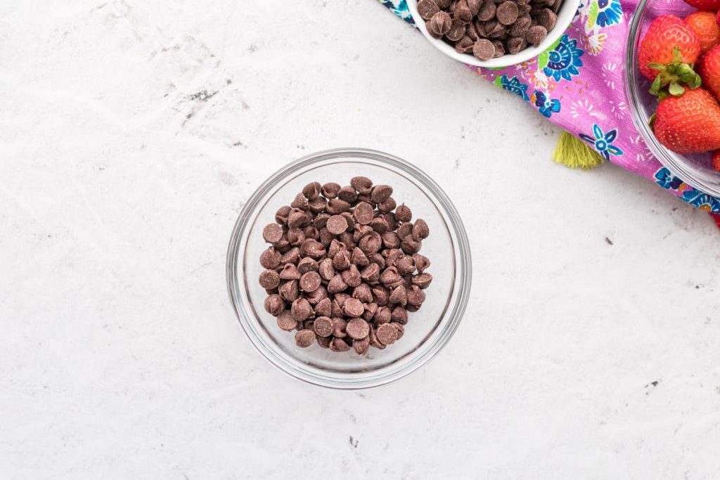 a small glass bowl full of chocolate chips