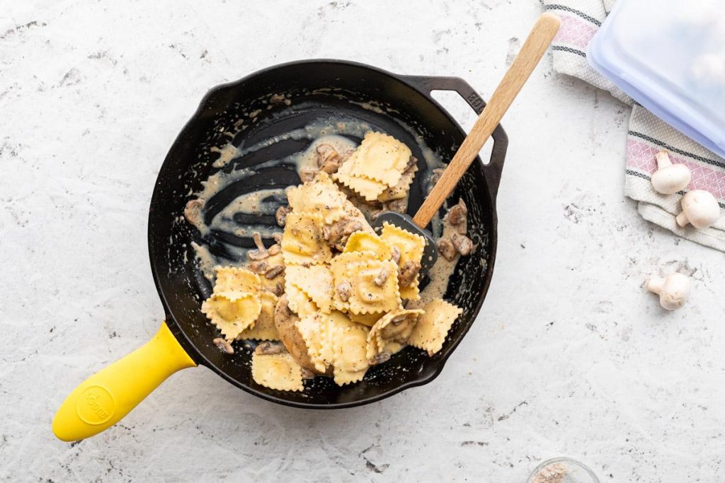 ravioli with mushrooms in a cast iron skillet