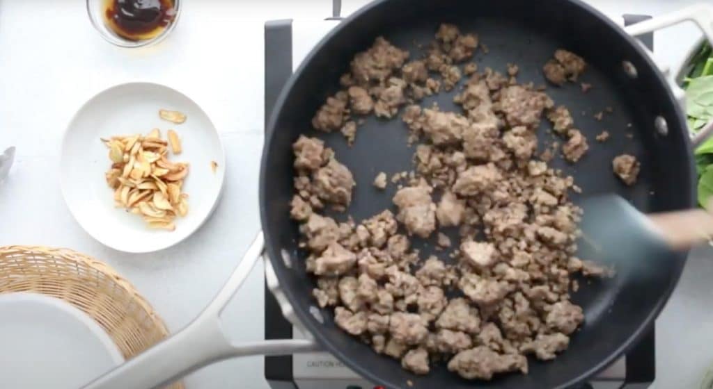 crumbled ground beef cooking in a black saucepan