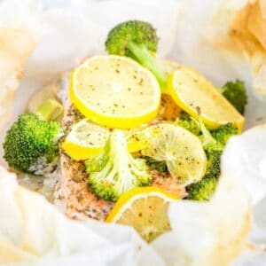 salmon with broccoli and lemon slices in parchment paper