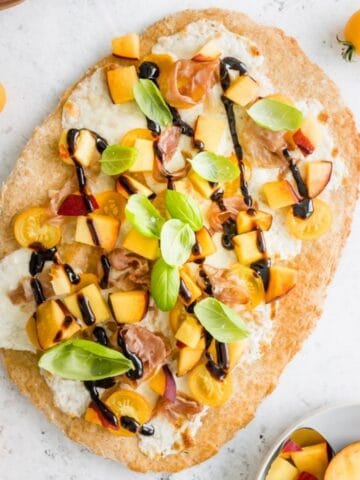 pizza with peaches, prosicutto, tomatoes, and balsamic