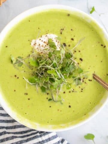 asparagus soup with micro greens and pepper on top