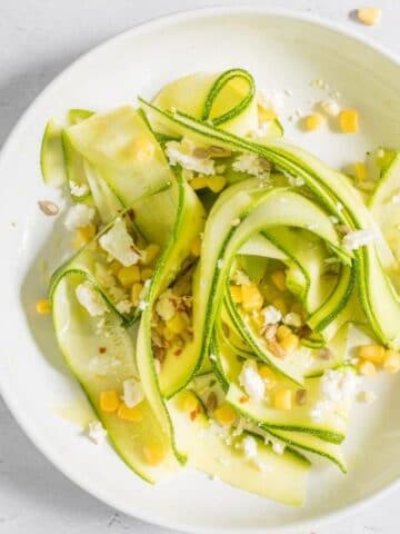 shaved zucchini, corn, and feta salad in a bowl