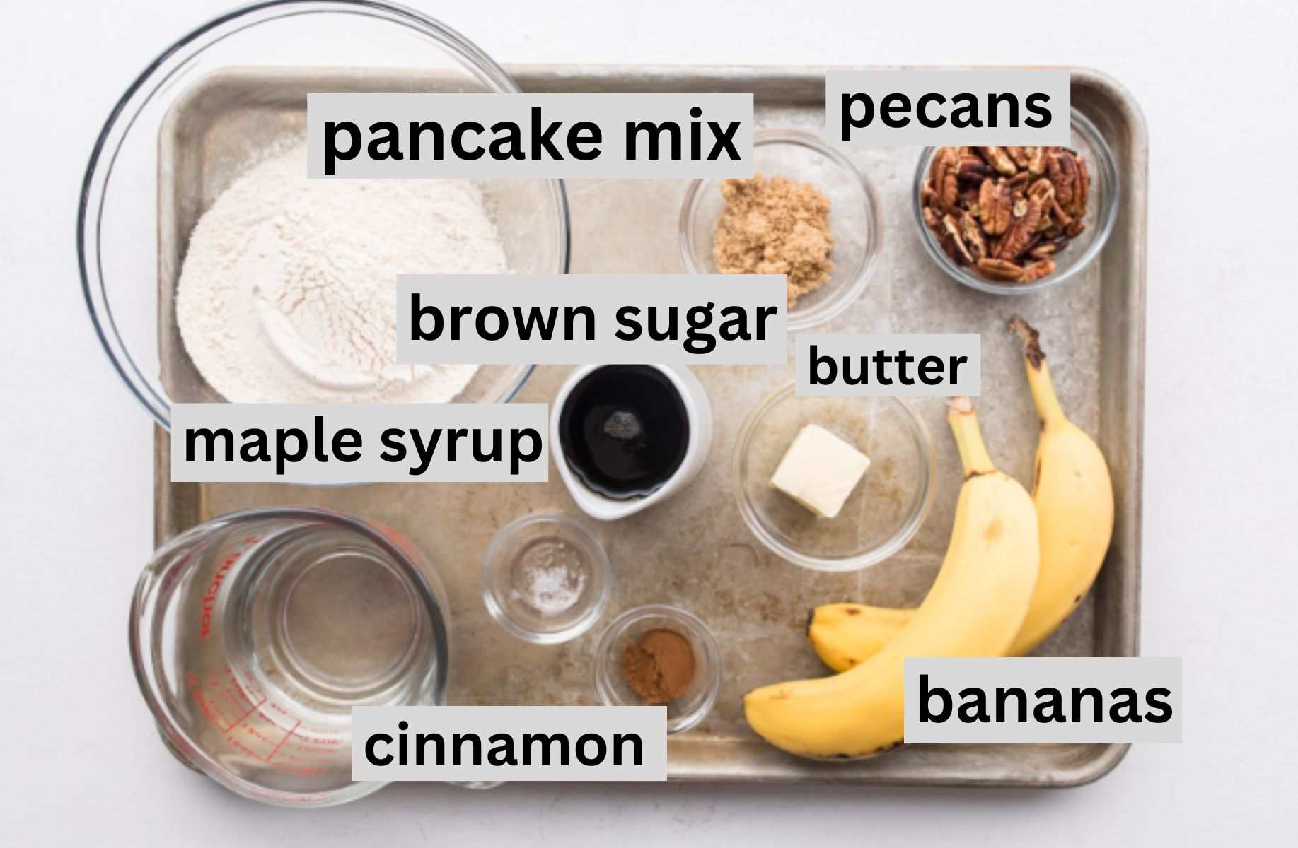 bananas, sugar, pancake mix, syrup, and other ingredients on a baking sheet