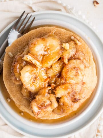 stack of pancakes with sauteed bananas on top