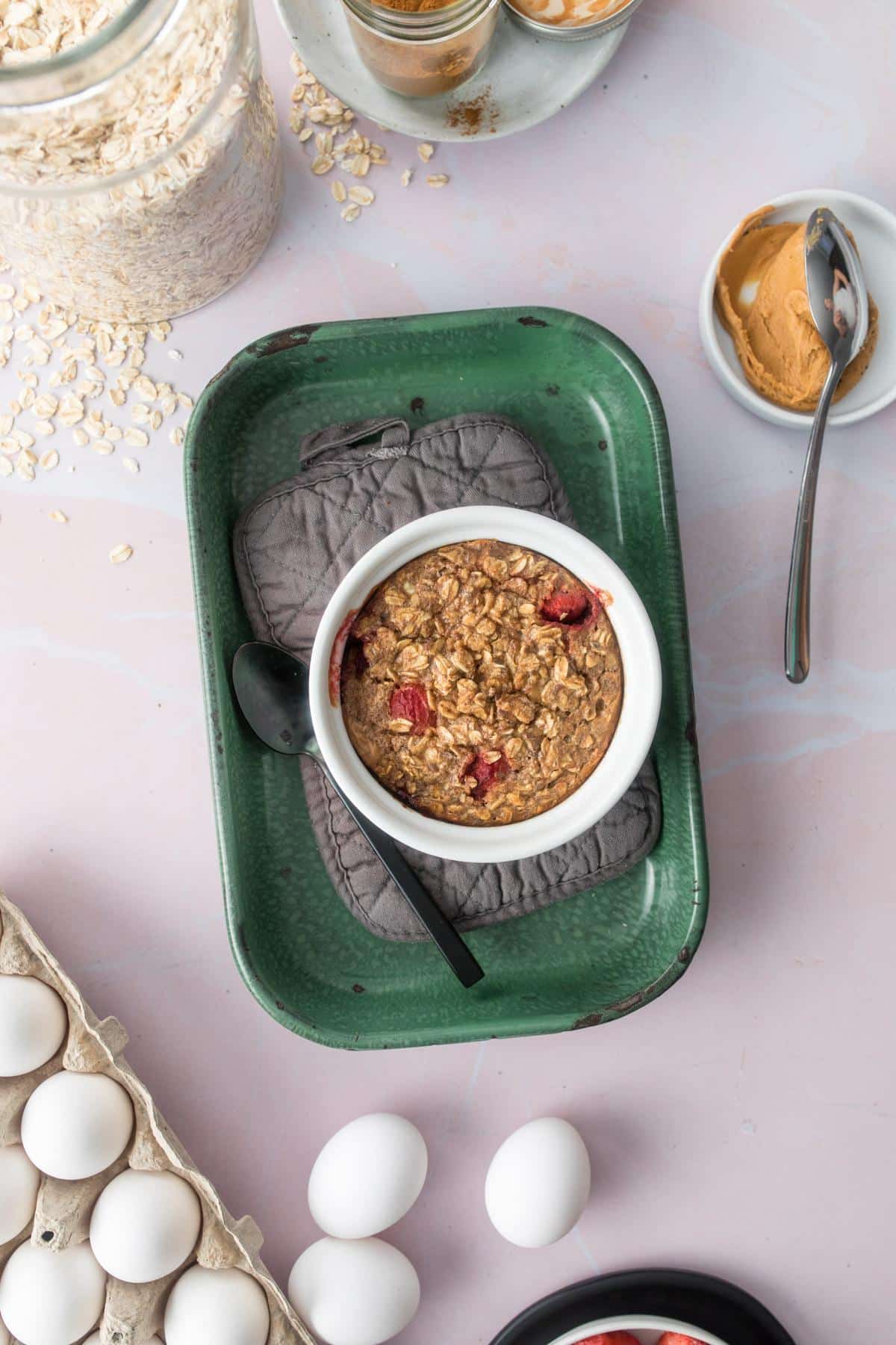 bowl of strawberry oatmeal sitting in green dish