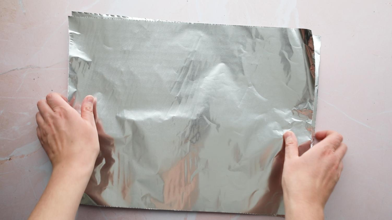 hands holding tin foil