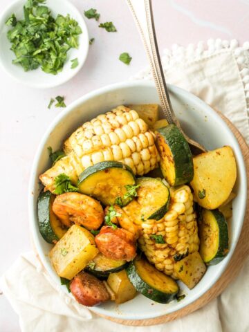 corn, zucchini, potatoes, and sausage in a bowl