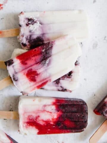 close up of berry and yogurt popsicles on a table