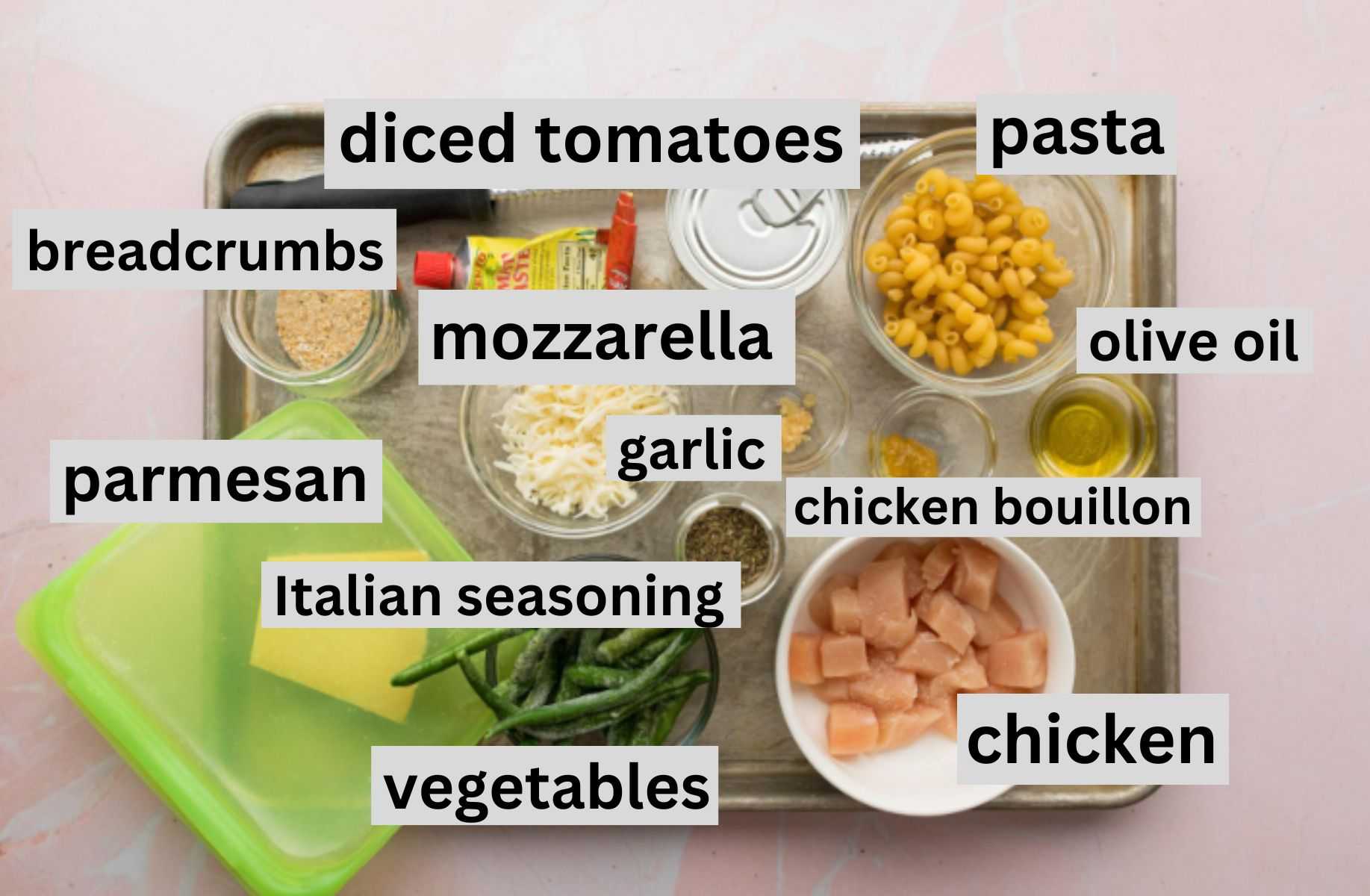 ingredients for chicken parmesan pasta on a cookie sheet