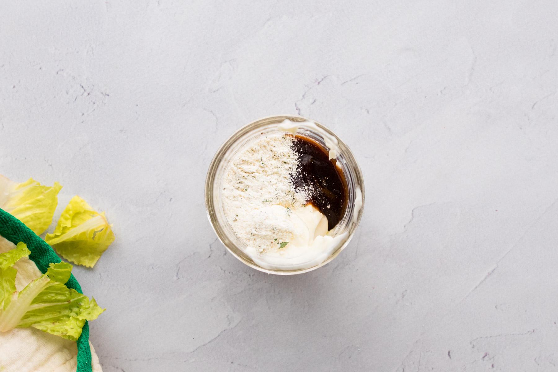 mayo, plain Greek yogurt, BBQ sauce, and ranch dressing powder in a glass jar