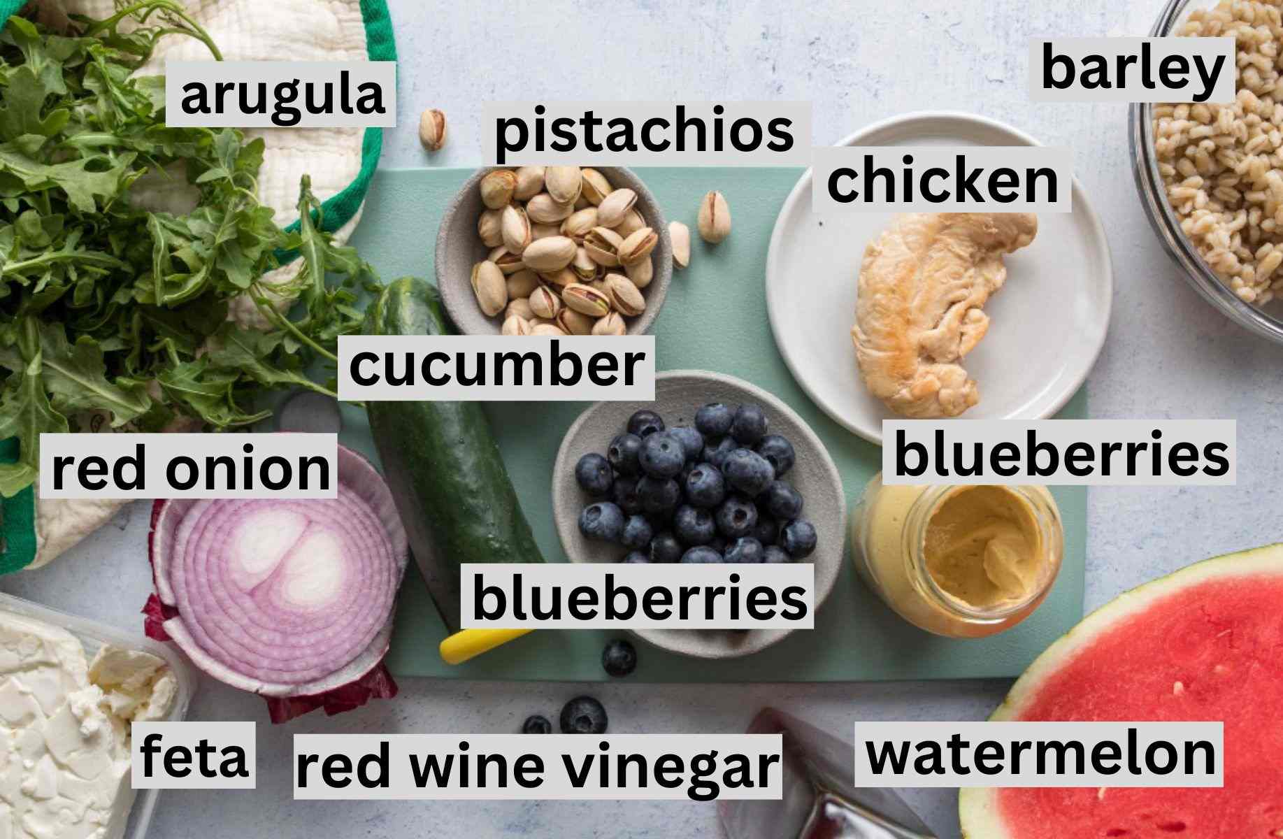 watermelon chicken salad ingredients on a cutting board