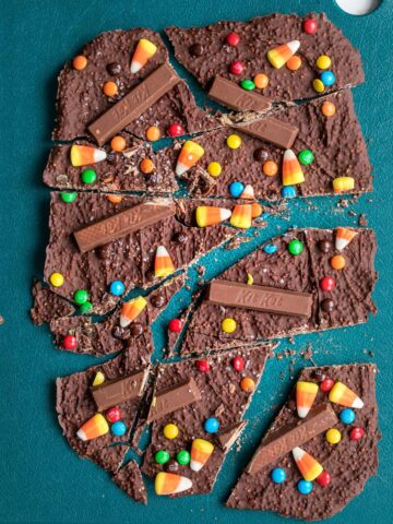 cut Halloween bark on a green cutting board