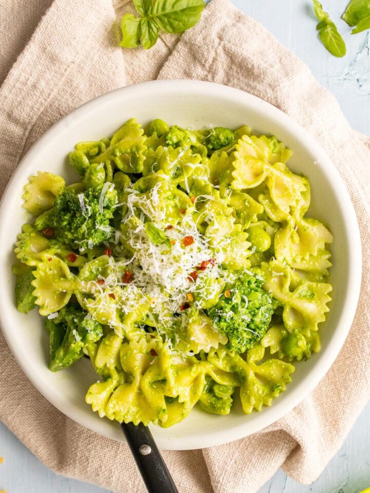pesto pasta with parmesan cheese on top