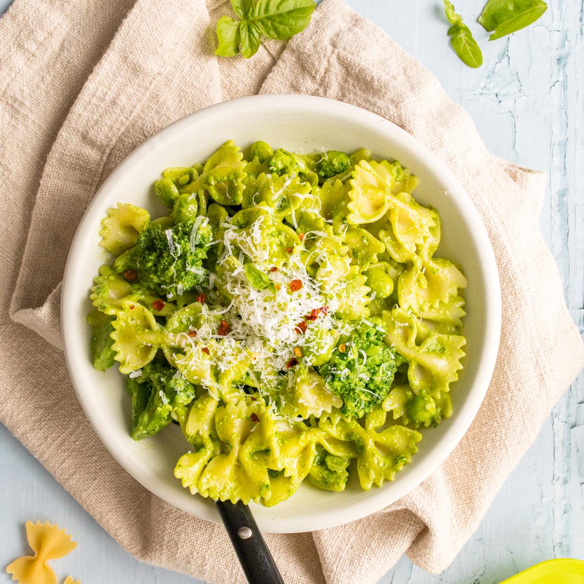 pesto pasta with parmesan cheese on top