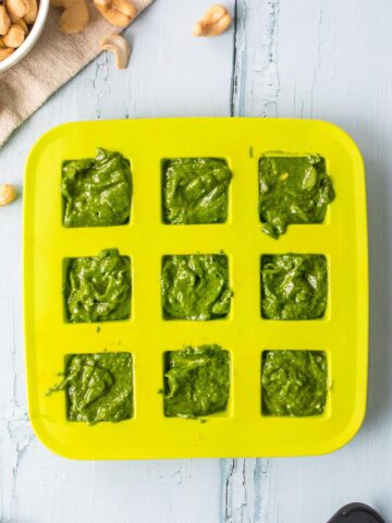 green pesto sauce in a green ice tray