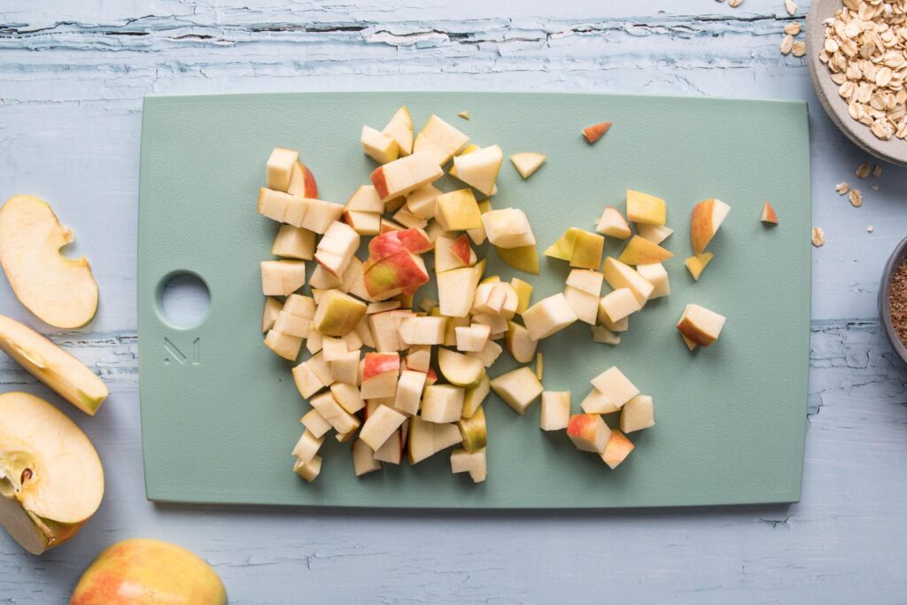 chopped apples on green cutting board