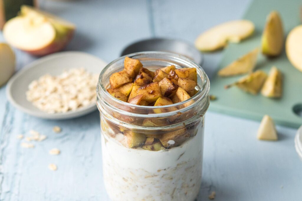 cooked apples over yogurt and oats in a jar