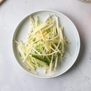 thin apple and cucumber slices on a plate