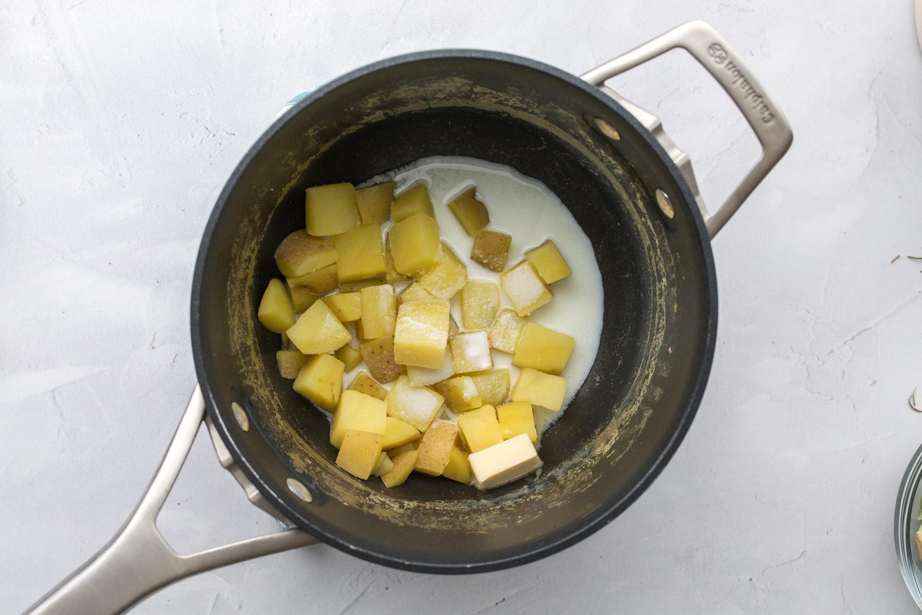 cubed potatoes and milk in a pot