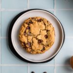square image of chocolate chip cookie on plate