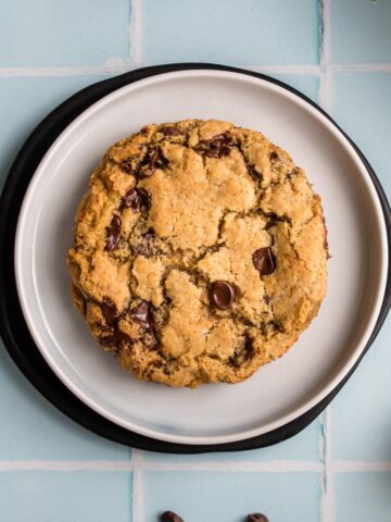 square image of chocolate chip cookie on plate