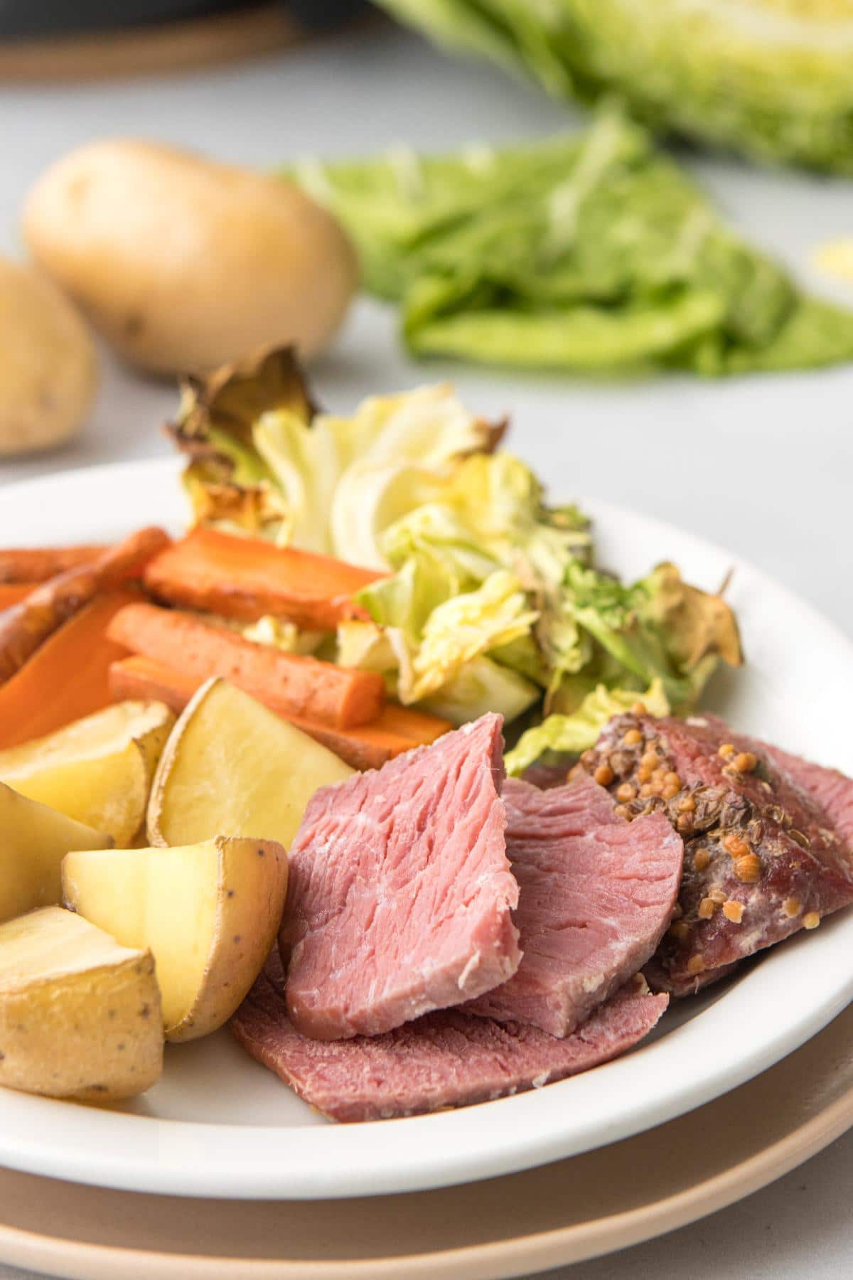 close up of corned beef and veggies on plate