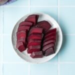 three rows of sliced beets on a plate