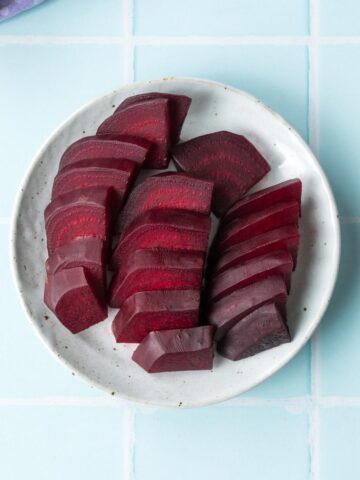 three rows of sliced beets on a plate